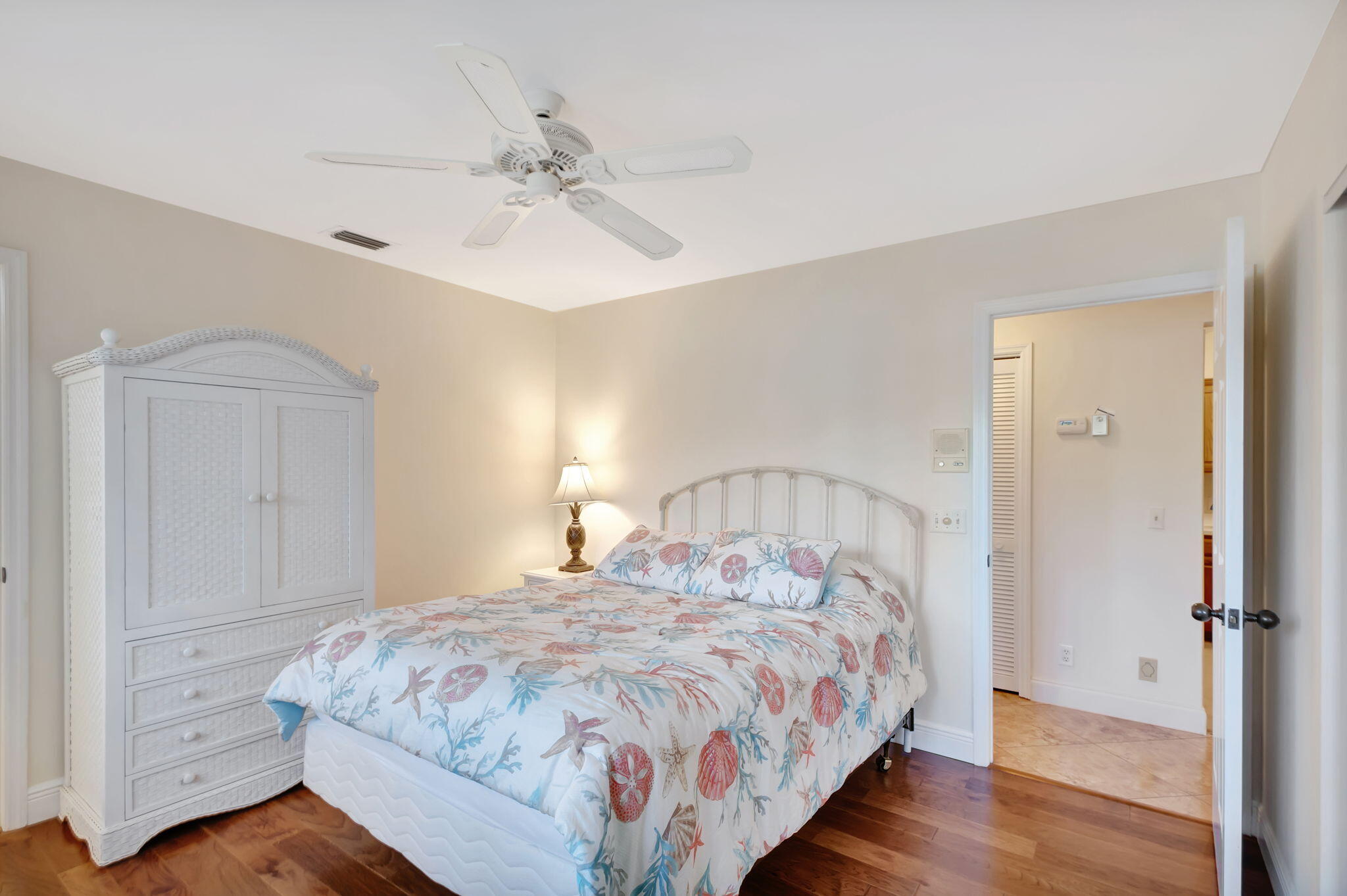 3790 Shearwater Drive Jupiter, FL 33477 - Photo 15 of 30 a bedroom with a bed and a chandelier