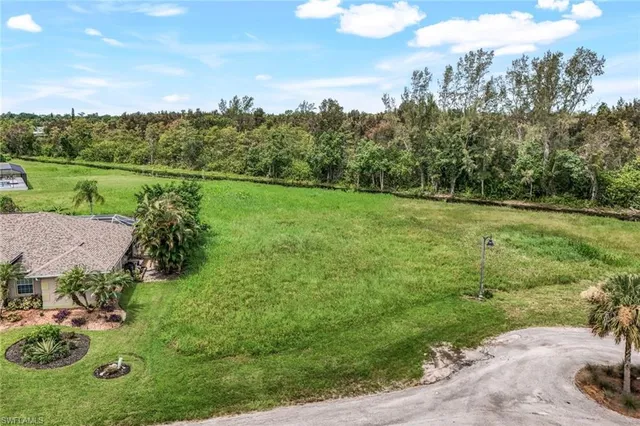 an aerial view of a golf course with parking space