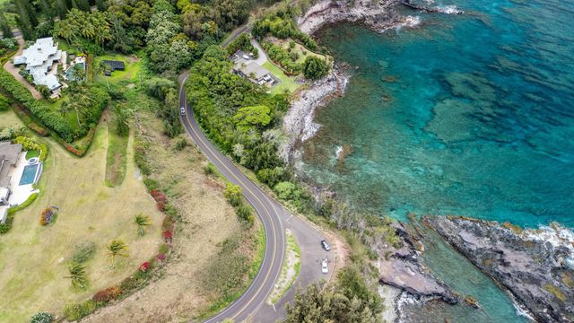 an aerial view of a residential houses with yard