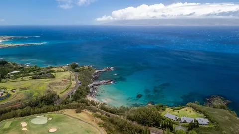 a view of a swimming pool with a yard