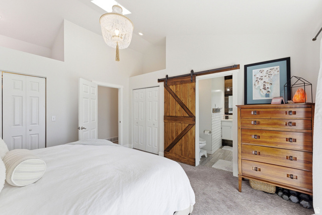7935 Mustang Loop Road Park City, UT 84098 - Photo 42 of 60 Vaulted ceiling bedroom featuring a skylight and a decorative chandelier