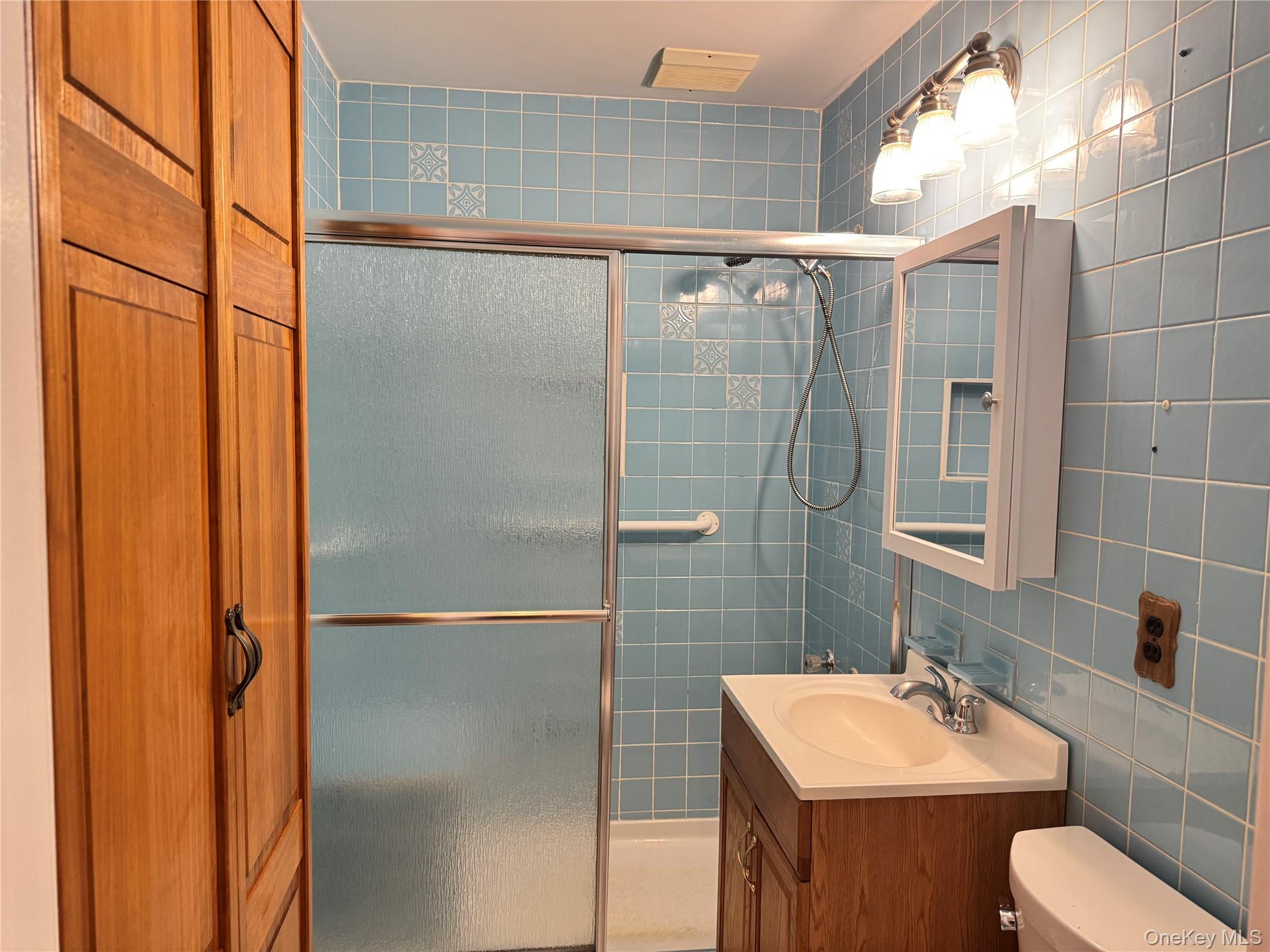 129 Spring Lane Levittown, NY 11756 - Photo 13 of 18 a bathroom with a sink toilet and shower