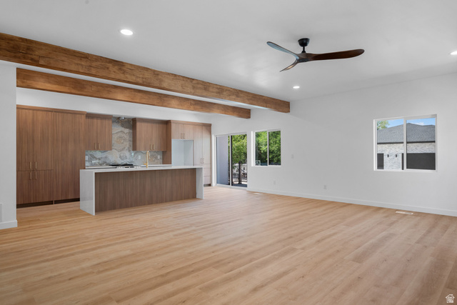 7238 South 525 East Midvale, UT 84047 - Photo 3 of 29 Open-concept living space with wood-finish flooring, exposed wood beams, and recessed lighting