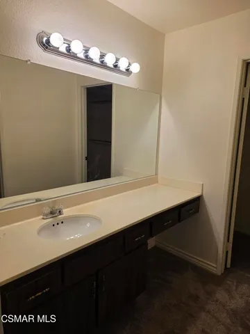 a bathroom with a sink double vanity and a mirror