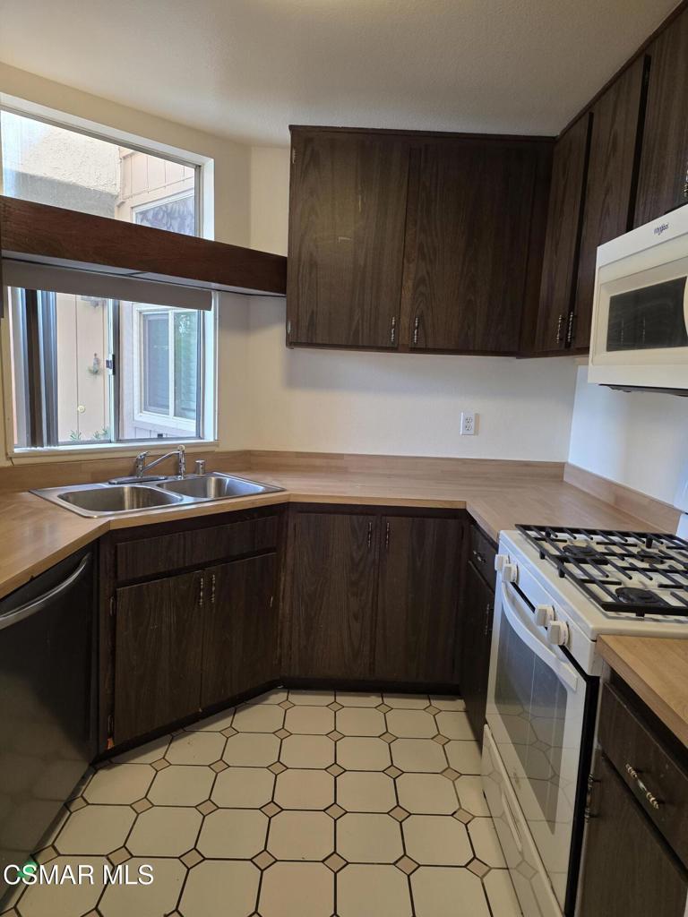 1778 Sinaloa Road, Unit 193 Simi Valley, CA 93065 - Photo 7 of 15 a kitchen with a sink a stove and cabinets