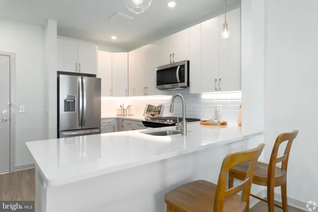 a kitchen with granite countertop a sink and a stove top oven