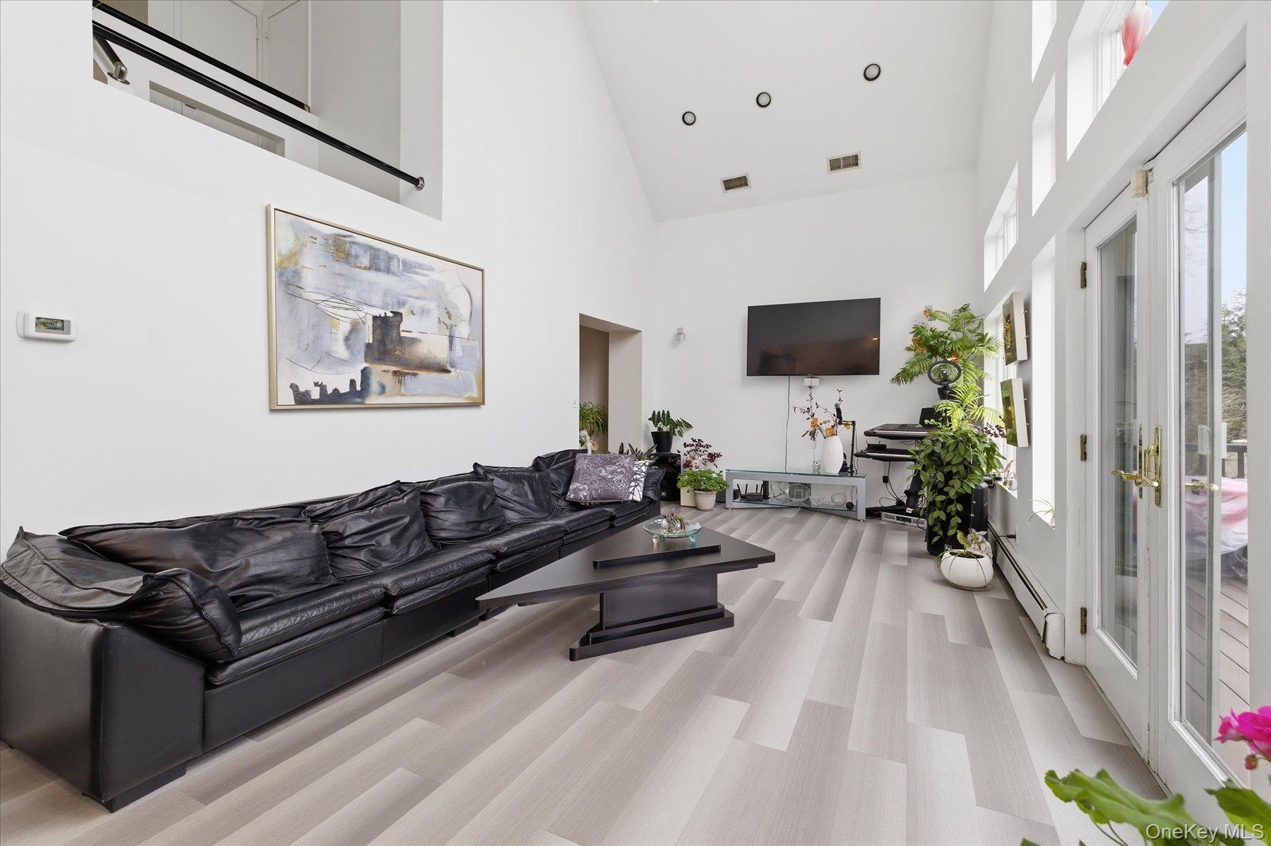 34 Reyam Road Lynbrook, NY 11563 - Photo 11 of 38 a living room with furniture and a flat screen tv