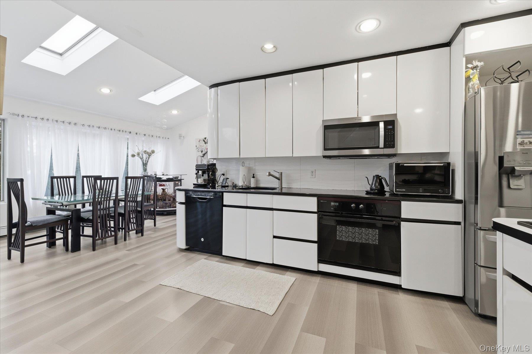 34 Reyam Road Lynbrook, NY 11563 - Photo 14 of 38 a kitchen with stainless steel appliances stove microwave and cabinets