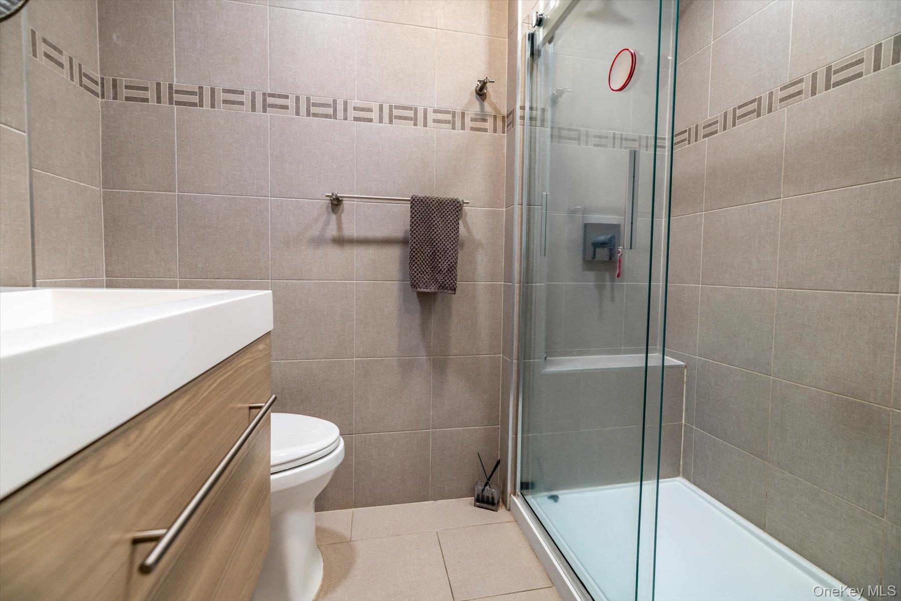 34 Reyam Road Lynbrook, NY 11563 - Photo 16 of 38 a bathroom with a shower and a toilet