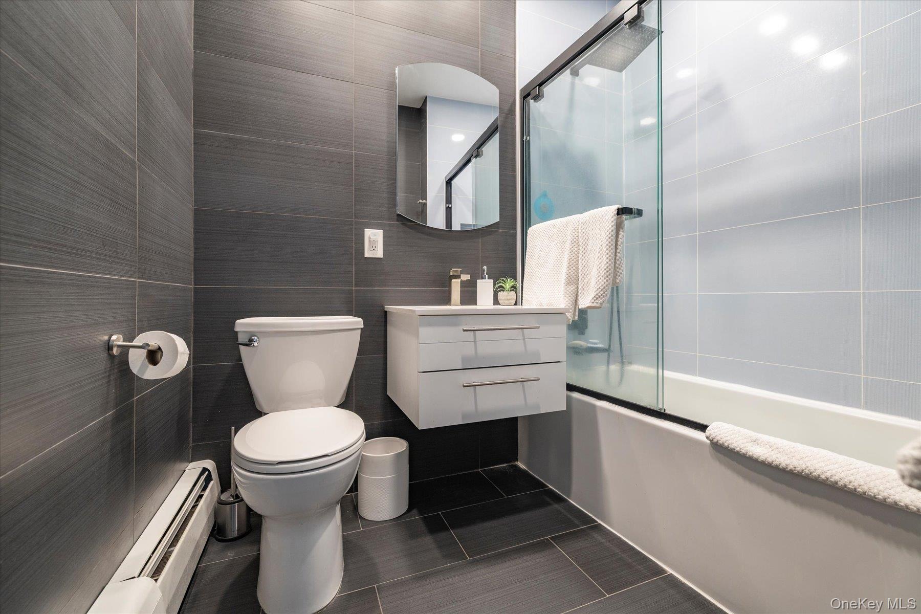 34 Reyam Road Lynbrook, NY 11563 - Photo 18 of 38 a bathroom with a toilet sink and mirror