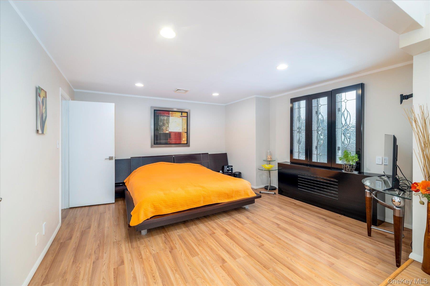 34 Reyam Road Lynbrook, NY 11563 - Photo 22 of 38 a bedroom with a bed and wooden floor