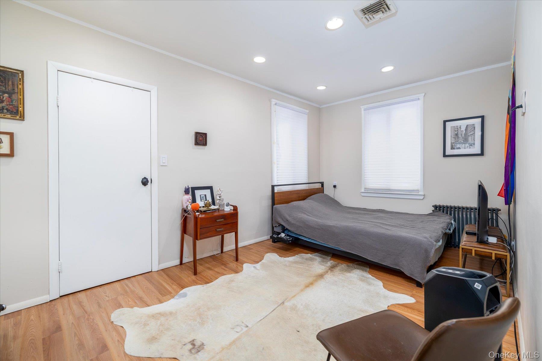 34 Reyam Road Lynbrook, NY 11563 - Photo 23 of 38 a bedroom with furniture and a wooden floor