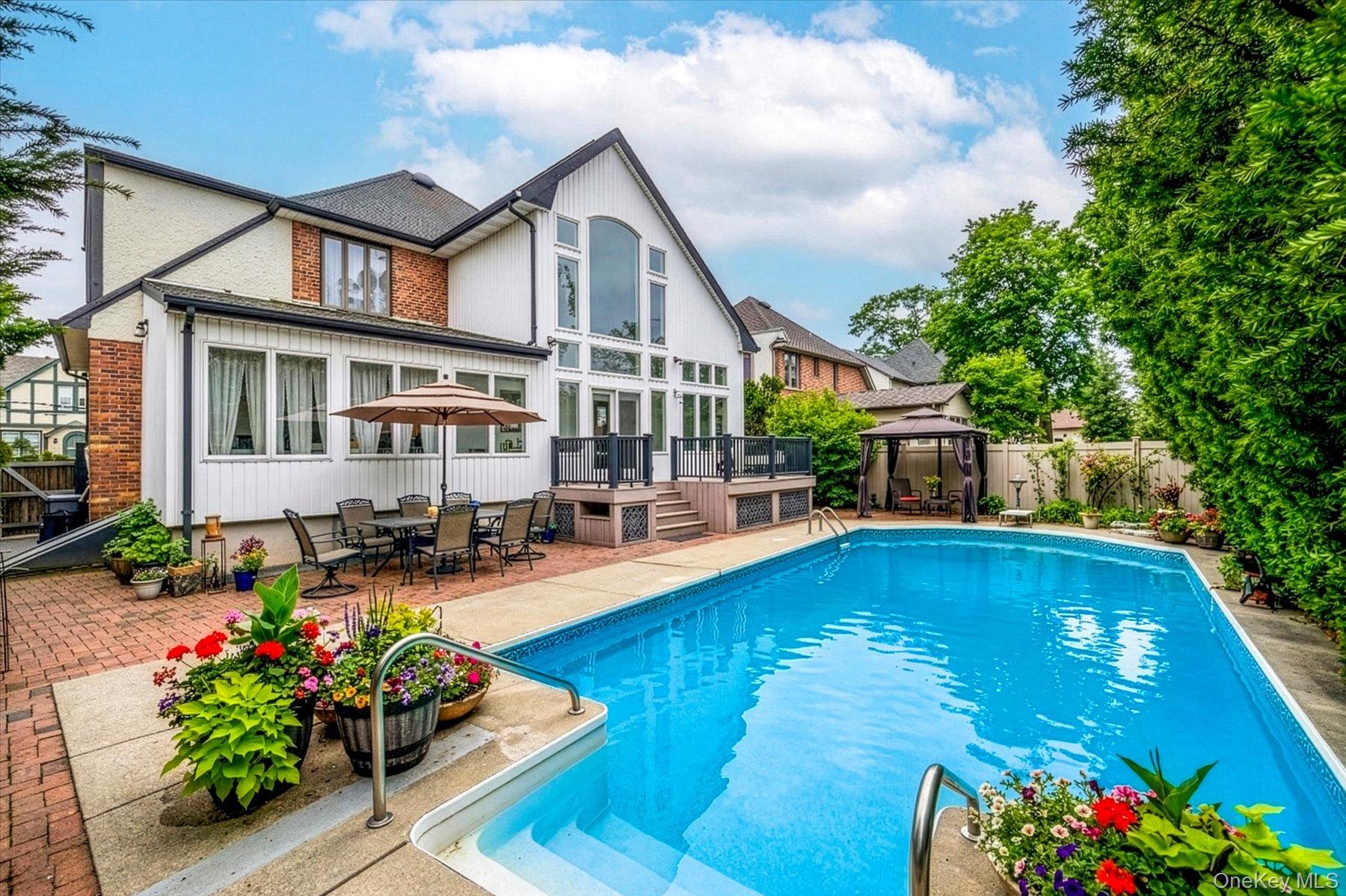 34 Reyam Road Lynbrook, NY 11563 - Photo 3 of 38 a front view of a house with swimming pool garden and patio