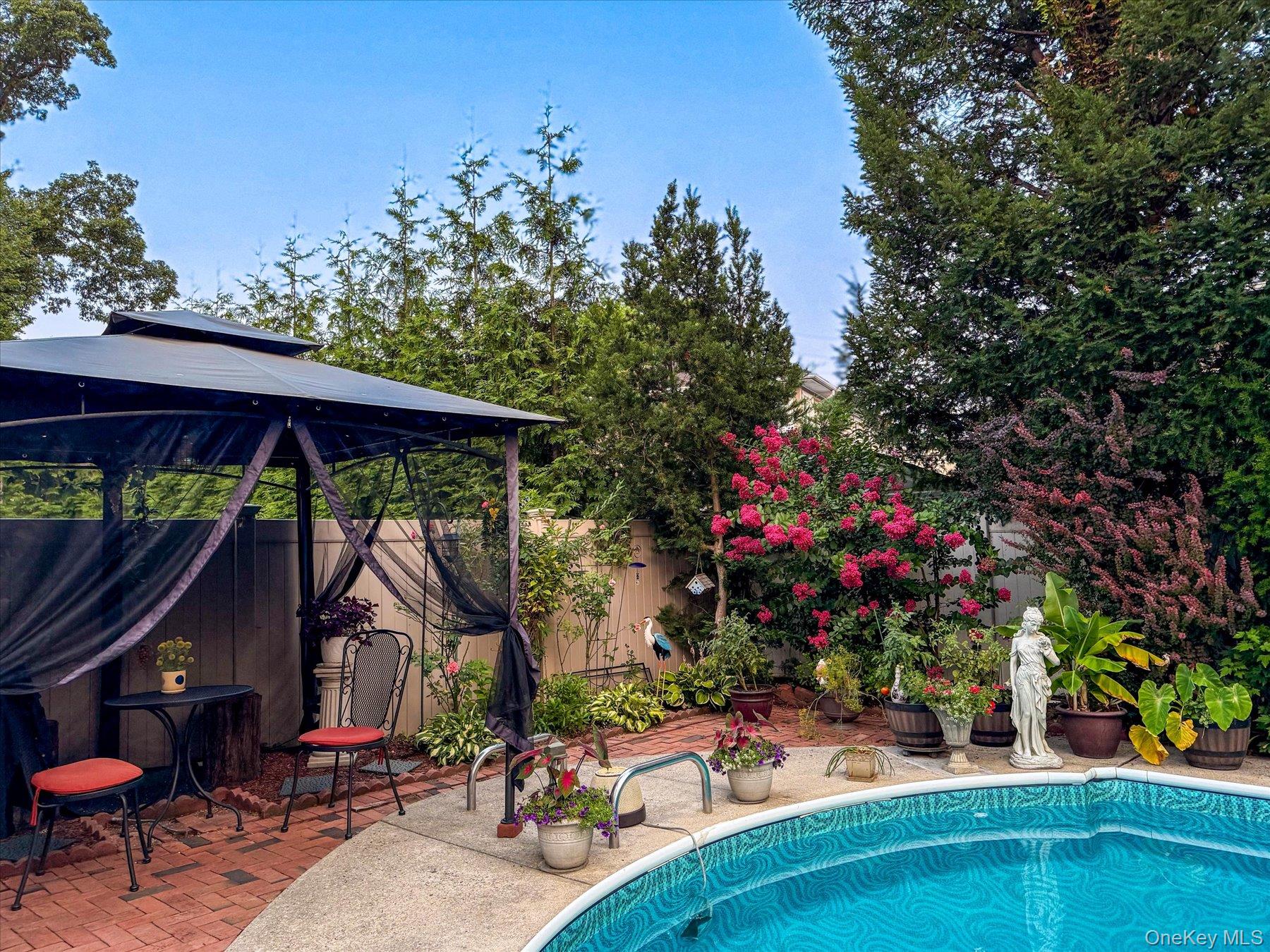 34 Reyam Road Lynbrook, NY 11563 - Photo 32 of 38 a view of patio with a table and chairs under an umbrella