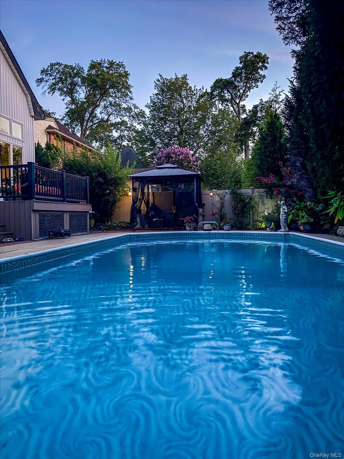 34 Reyam Road Lynbrook, NY 11563 - Photo 33 of 38 a swimming pool with outdoor seating and garden