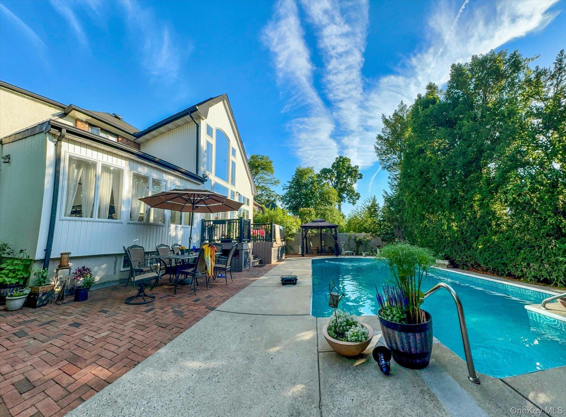34 Reyam Road Lynbrook, NY 11563 - Photo 34 of 38 a backyard of a house with a fountain