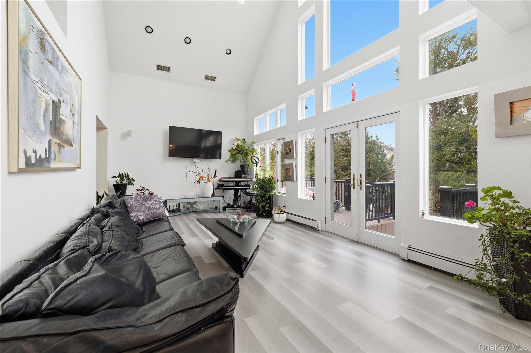 34 Reyam Road Lynbrook, NY 11563 - Photo 10 of 38 a living room with furniture and a flat screen tv