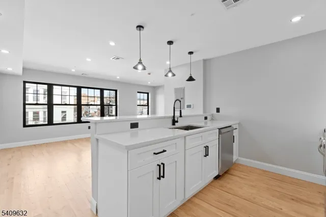 a large white kitchen with a large window