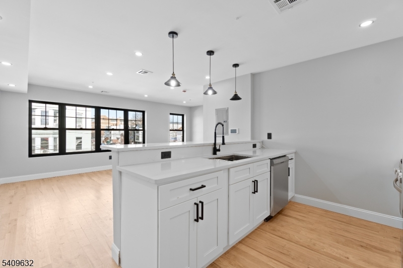 a large white kitchen with a large window