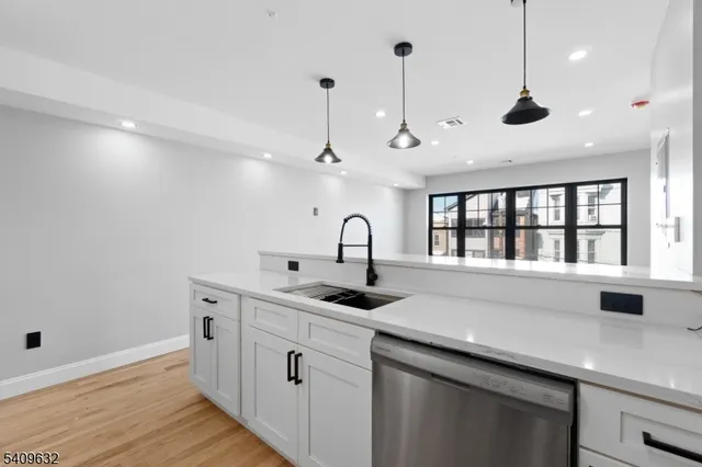 a kitchen with stainless steel appliances granite countertop a sink and a window