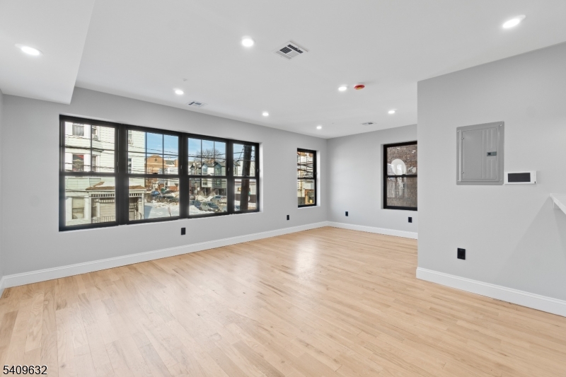 477 15th Avenue, Unit 2 Newark, NJ 07103 - Photo 4 of 11 a view of an empty room with a window and a kitchen