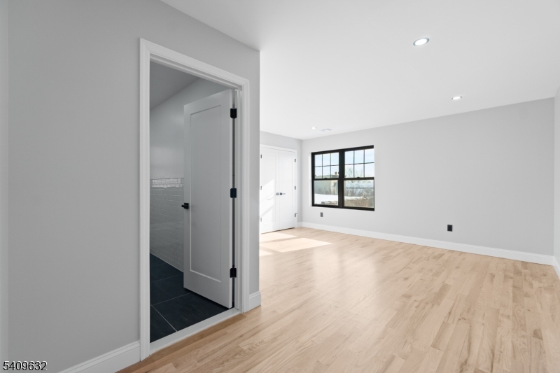 477 15th Avenue, Unit 2 Newark, NJ 07103 - Photo 6 of 11 wooden floor in an empty room with a window
