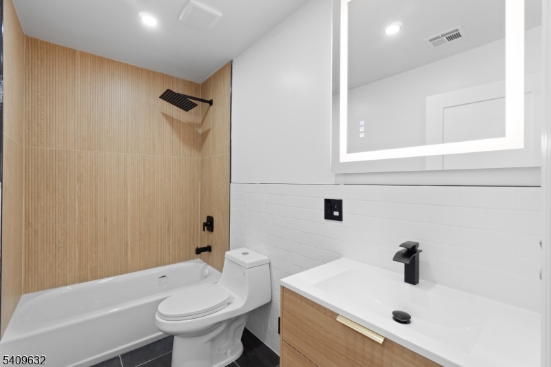 477 15th Avenue, Unit 2 Newark, NJ 07103 - Photo 9 of 11 a bathroom with a sink a toilet and shower