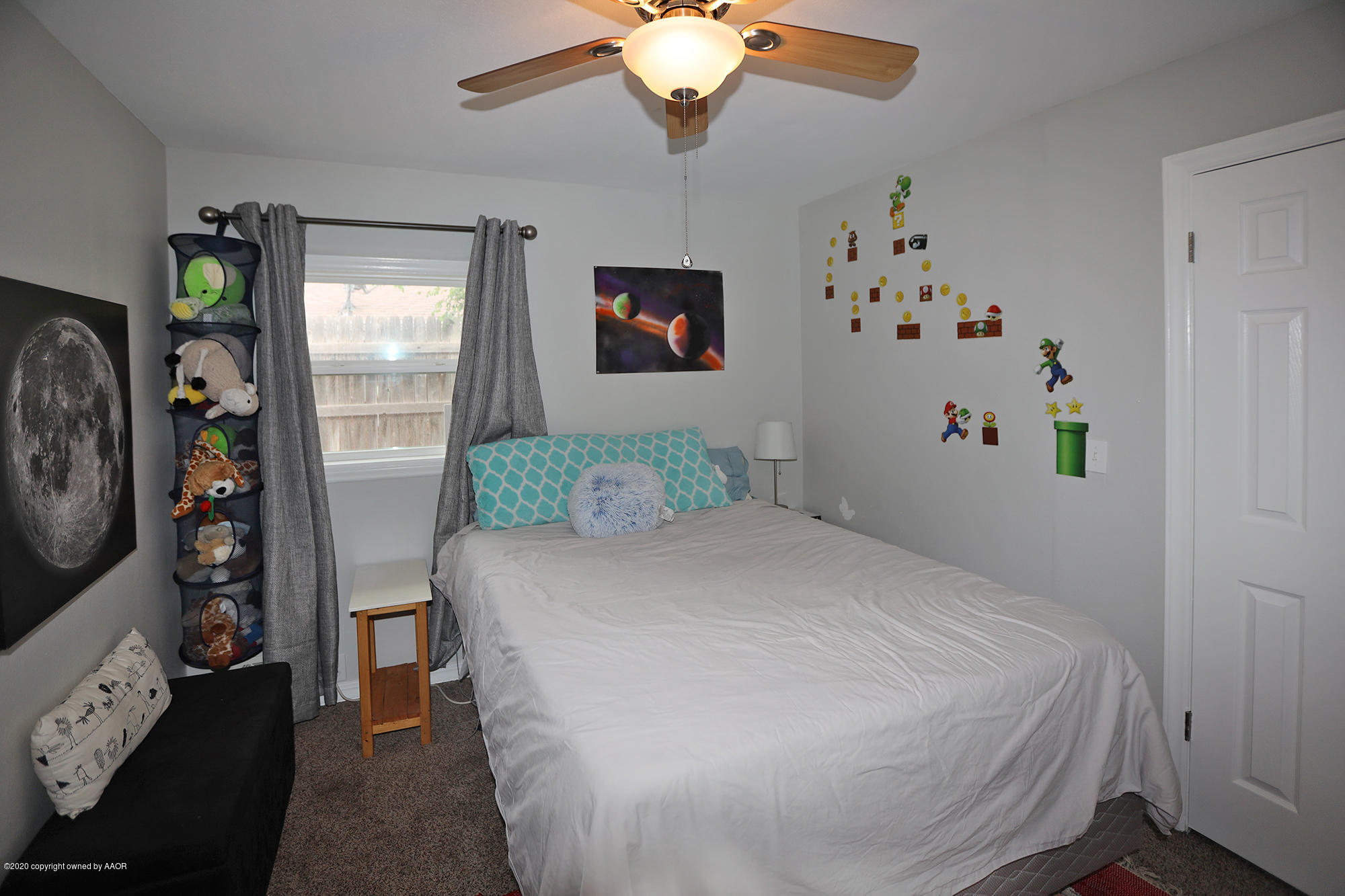 6018 Gainsborough Road Amarillo, TX 79106 - Photo 23 of 38 a bedroom with a bed and a chandelier