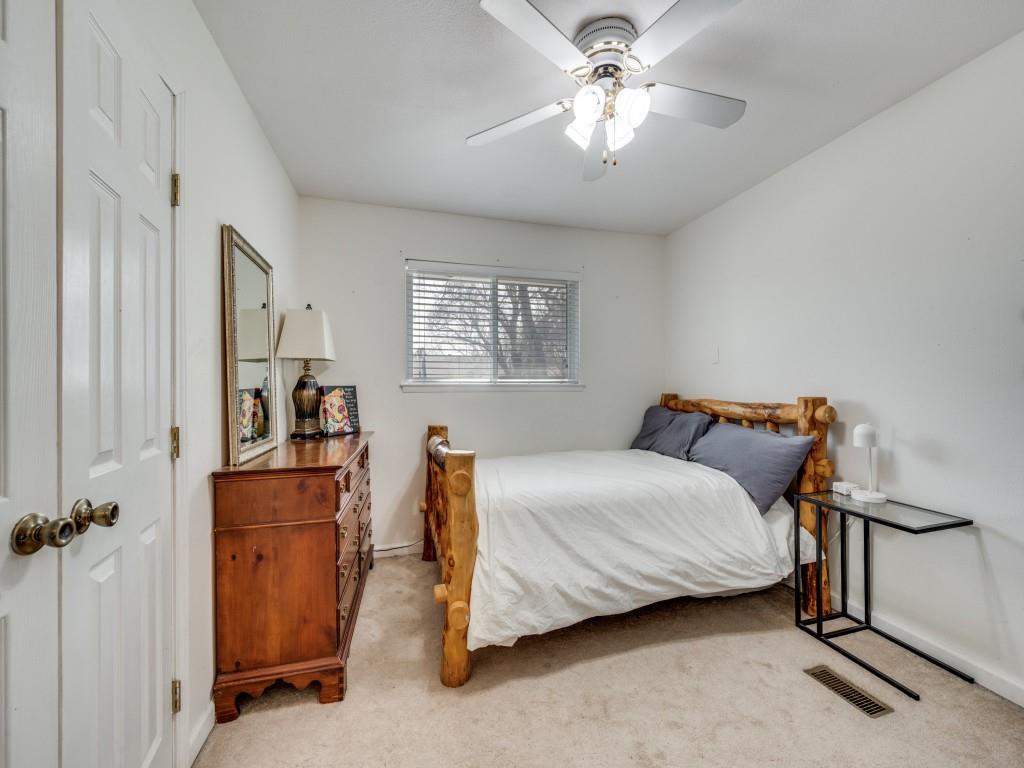 9835 Estate Lane Dallas, TX 75238 - Photo 20 of 25 Bedroom featuring light carpet and a ceiling fan