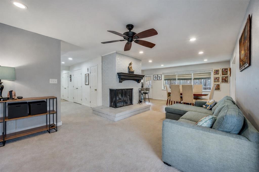 9835 Estate Lane Dallas, TX 75238 - Photo 7 of 25 Living room with ceiling fan, carpet floors, recessed lighting, and a fireplace