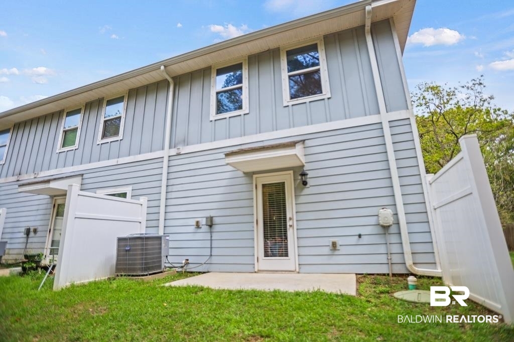 25806 Pollard Road, Unit 27 Daphne, AL 36526 - Photo 11 of 46 Back of house featuring board and batten siding and a patio