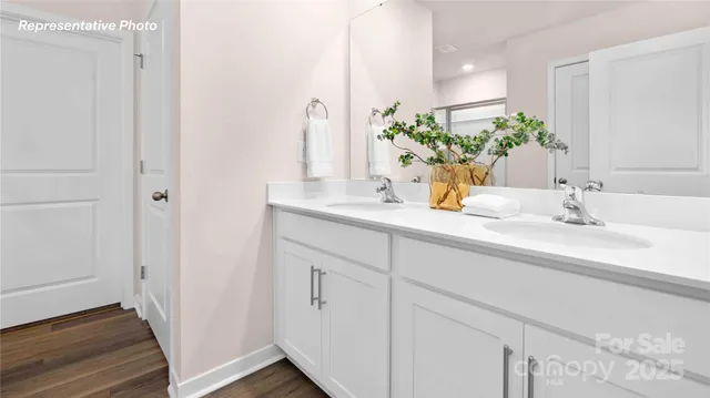 a bathroom with a granite countertop sink a toilet and shower