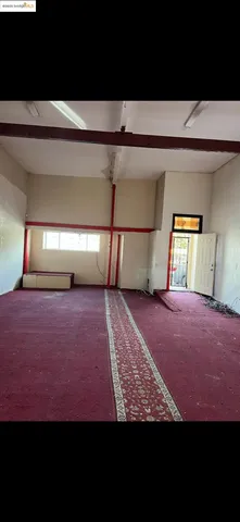 a view of empty room with a fireplace