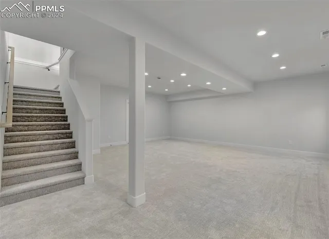 a view of an empty room with stairs