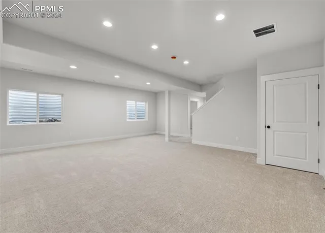 an empty room with windows and closet