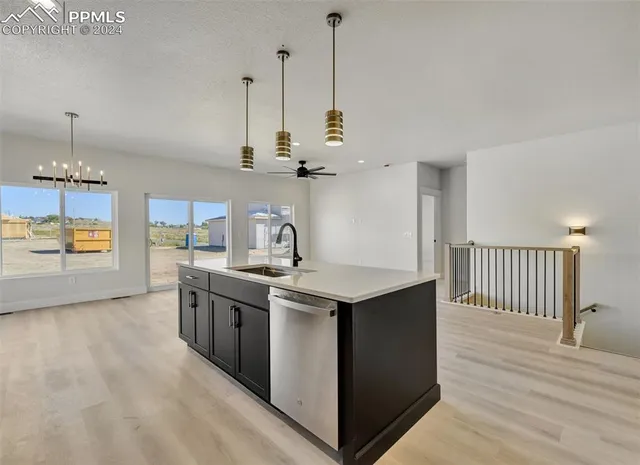 a kitchen with kitchen island a sink stove and wooden floor