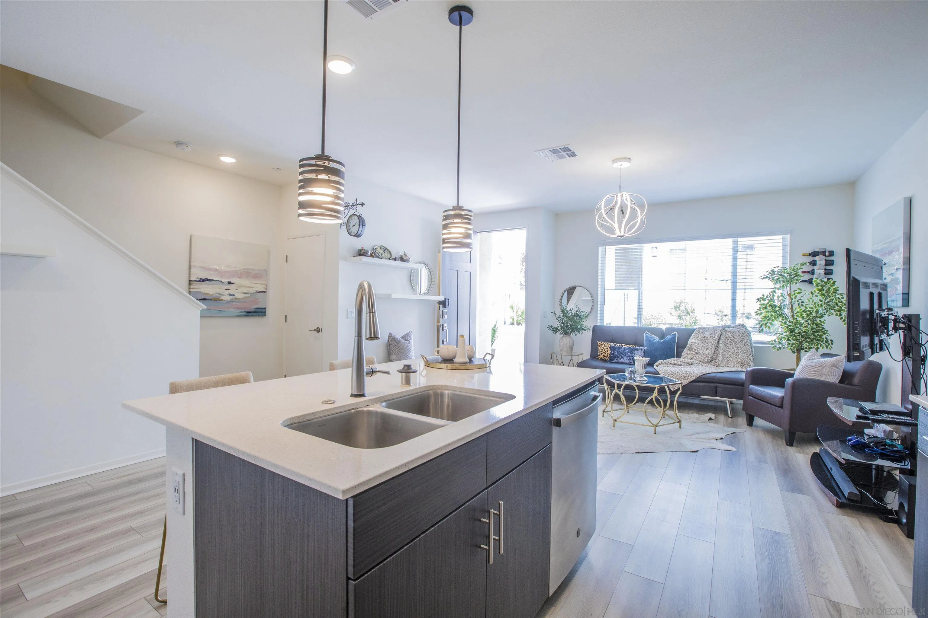356 Sweet Place Fallbrook, CA 92028 - Photo 4 of 12 a kitchen with sink refrigerator and couches with wooden floor