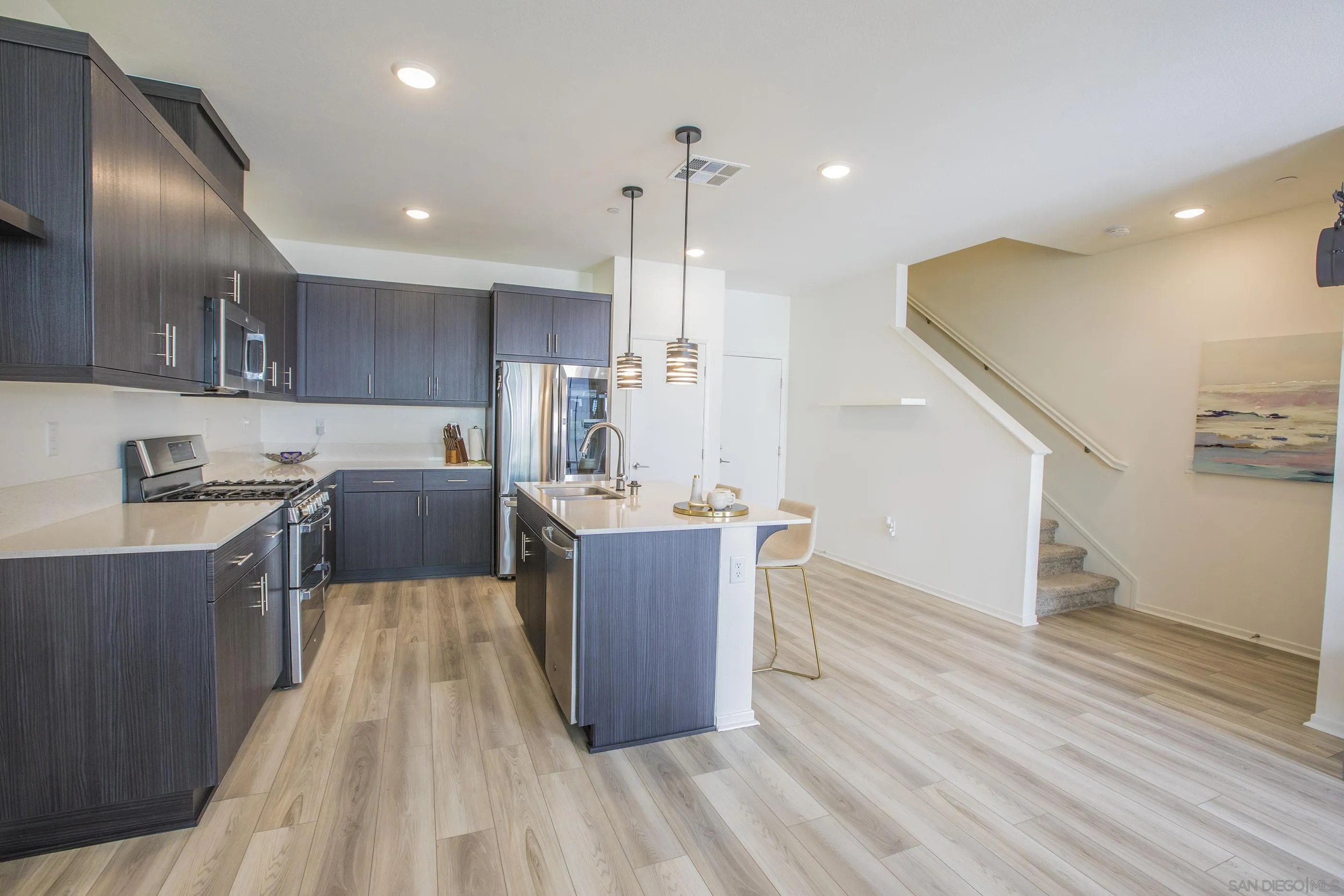 356 Sweet Place Fallbrook, CA 92028 - Photo 5 of 12 a room with wooden floors and kitchen view