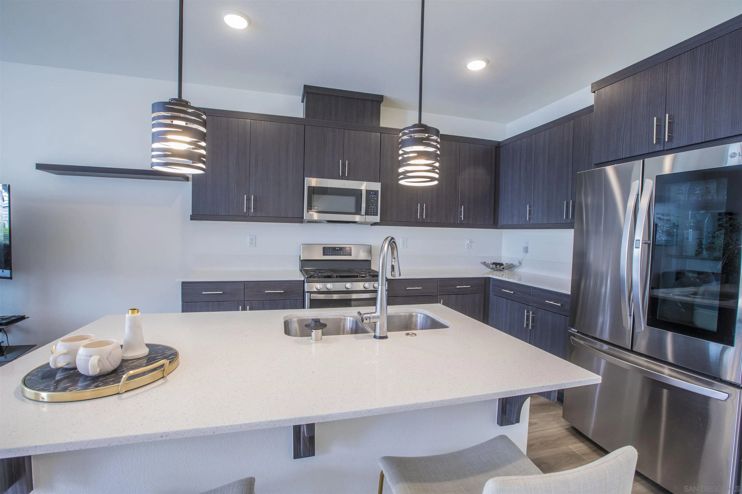 356 Sweet Place Fallbrook, CA 92028 - Photo 6 of 12 a kitchen with stainless steel appliances a table chairs and stove