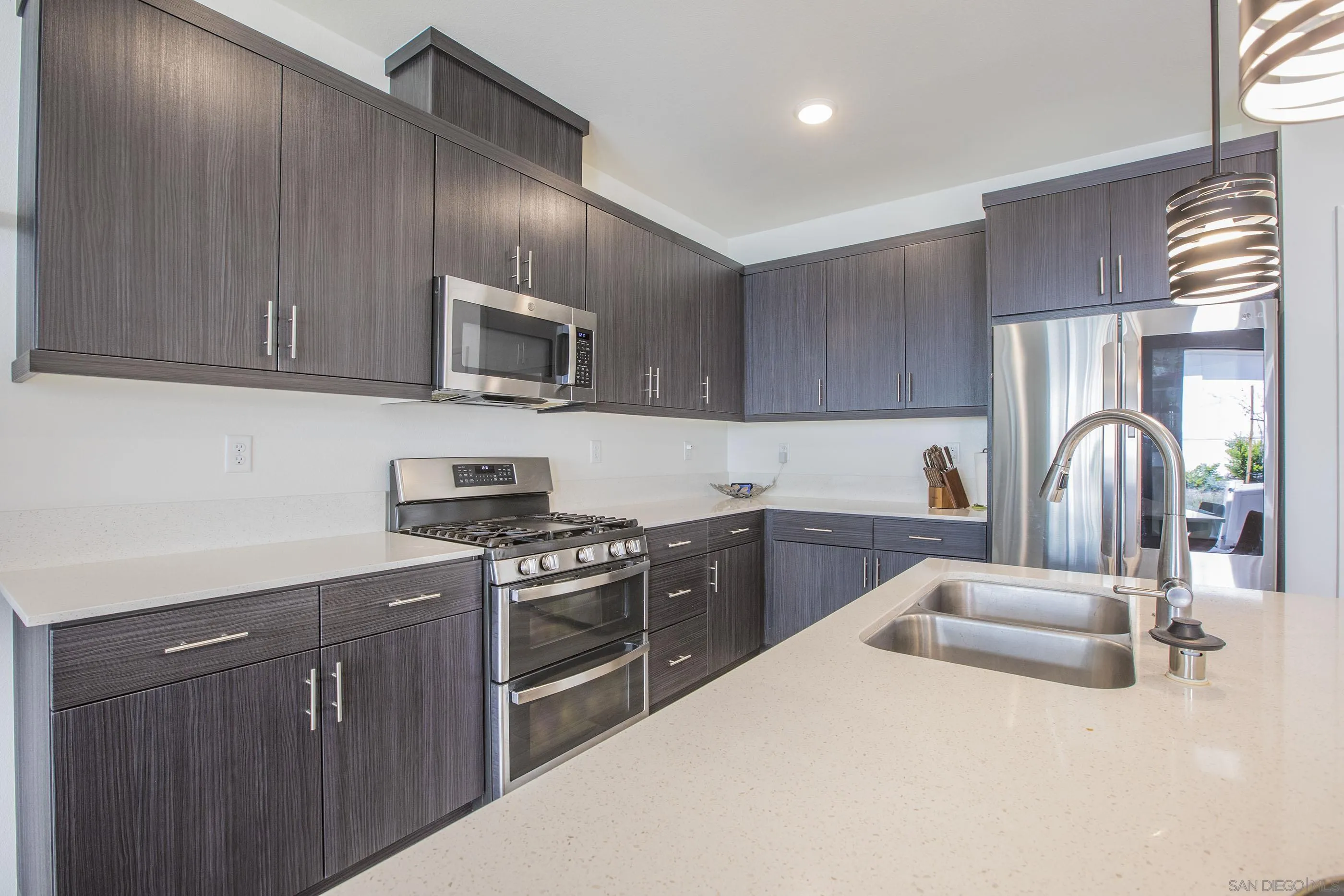 356 Sweet Place Fallbrook, CA 92028 - Photo 8 of 12 a kitchen with stainless steel appliances granite countertop a stove sink and cabinets