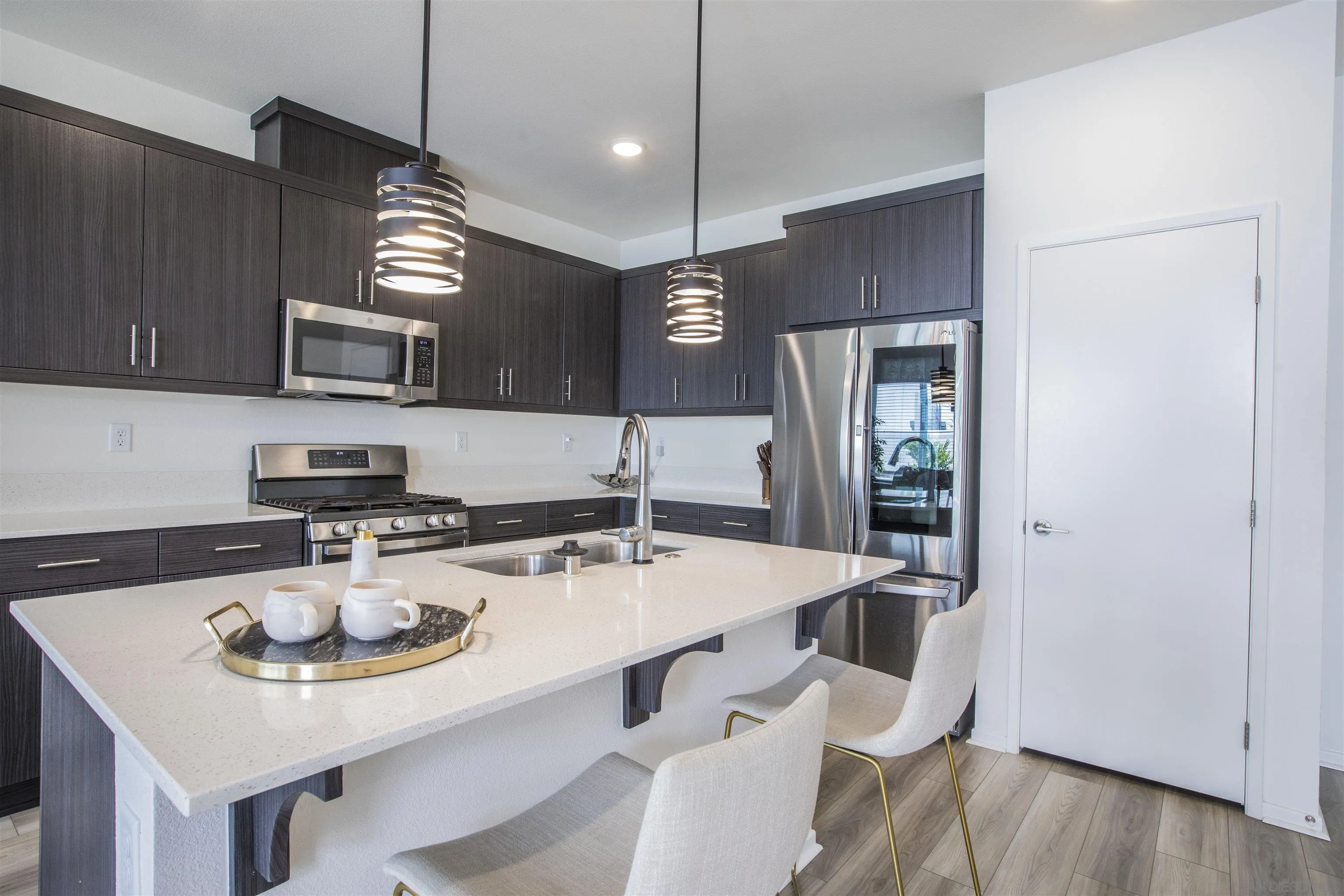 356 Sweet Place Fallbrook, CA 92028 - Photo 9 of 12 a kitchen with stainless steel appliances a sink a microwave a refrigerator and chairs