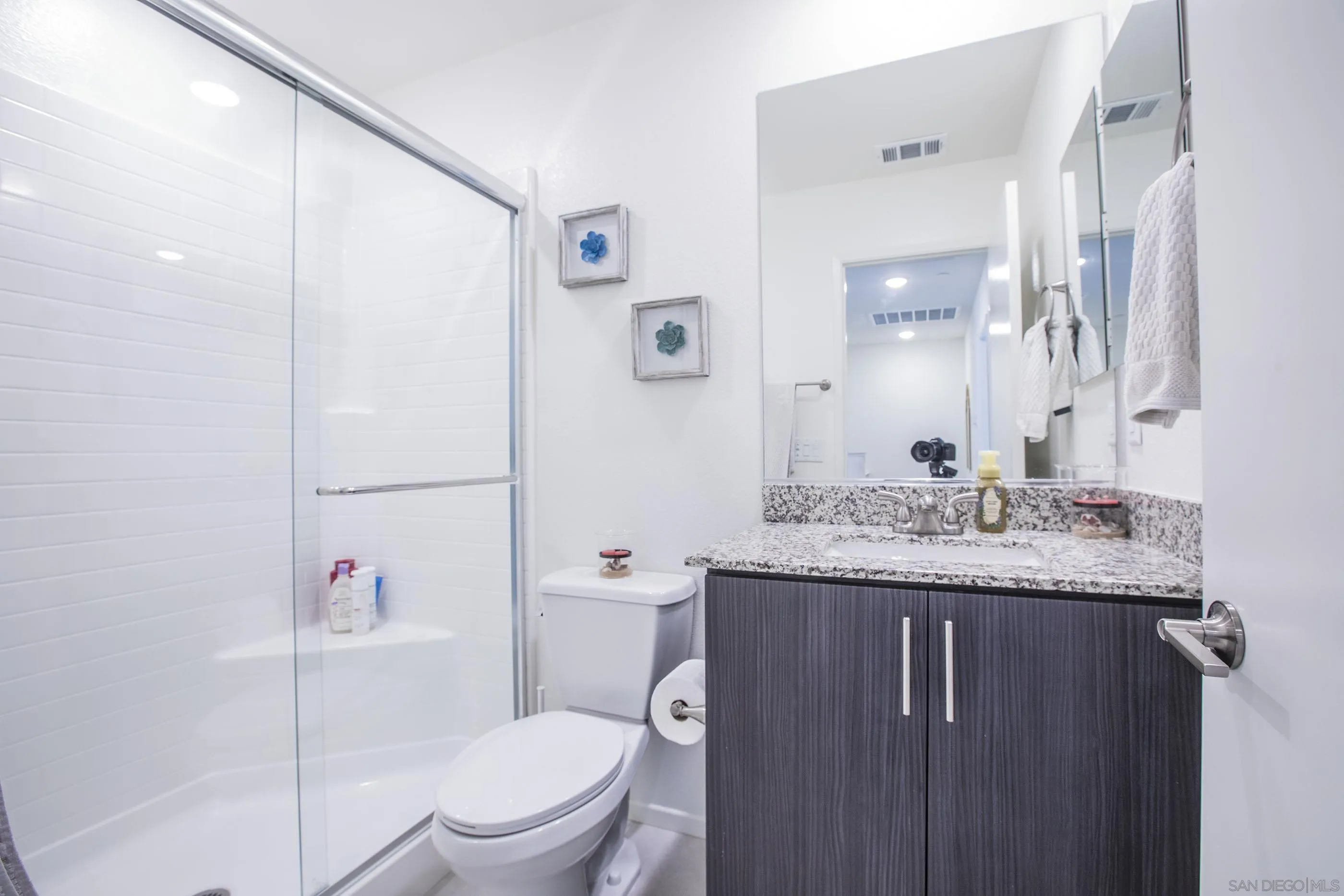 356 Sweet Place Fallbrook, CA 92028 - Photo 10 of 12 a bathroom with a granite countertop sink a toilet a mirror and shower