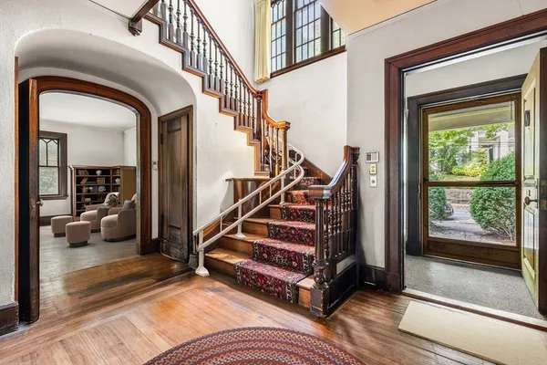 a view of entryway and hall with wooden floor