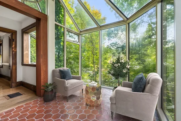 a living room with furniture and a floor to ceiling window