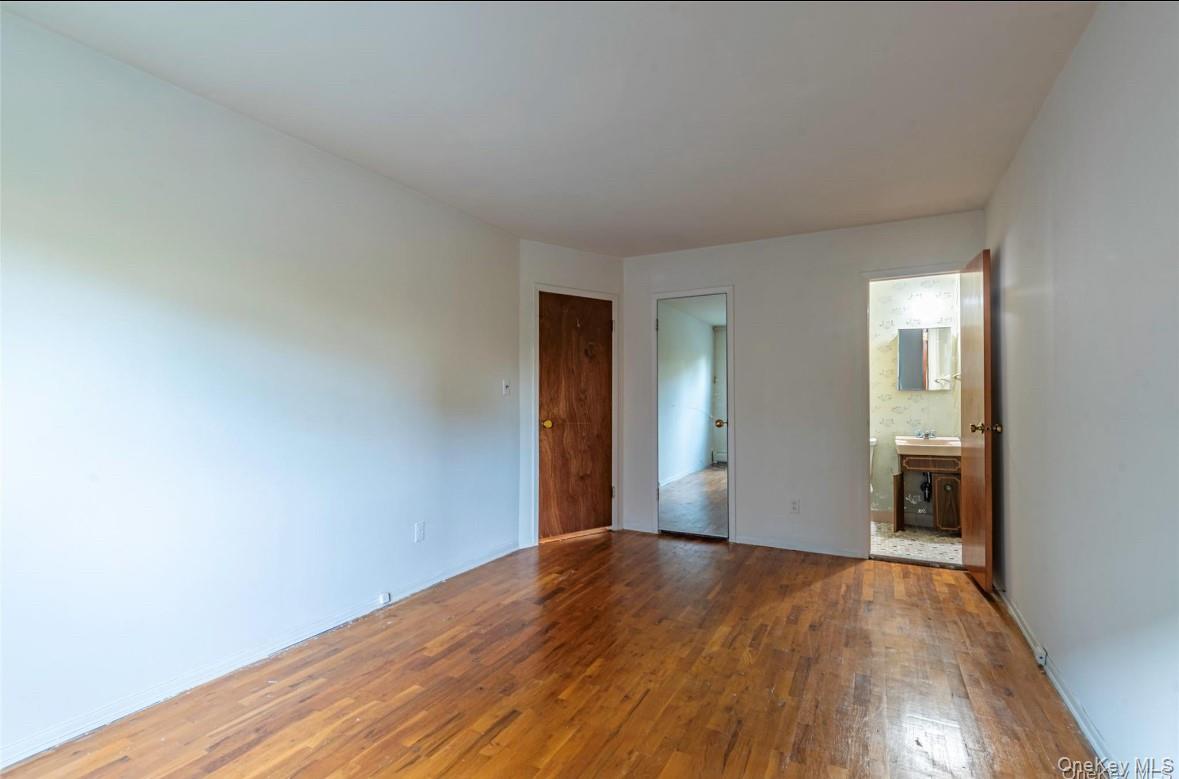 18-16 Bell Boulevard, Unit 2 Queens, NY 11360 - Photo 6 of 8 a view of empty room with wooden floor