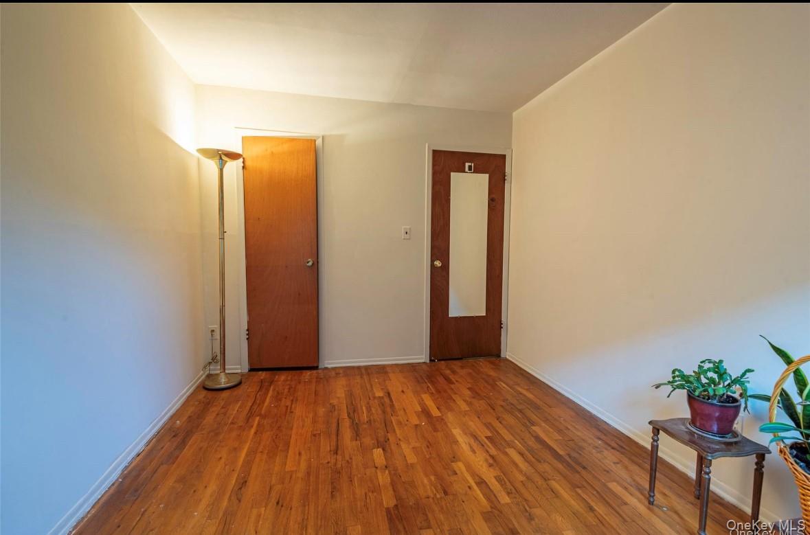 18-16 Bell Boulevard, Unit 2 Queens, NY 11360 - Photo 8 of 8 a view of a room with wooden floor and bench