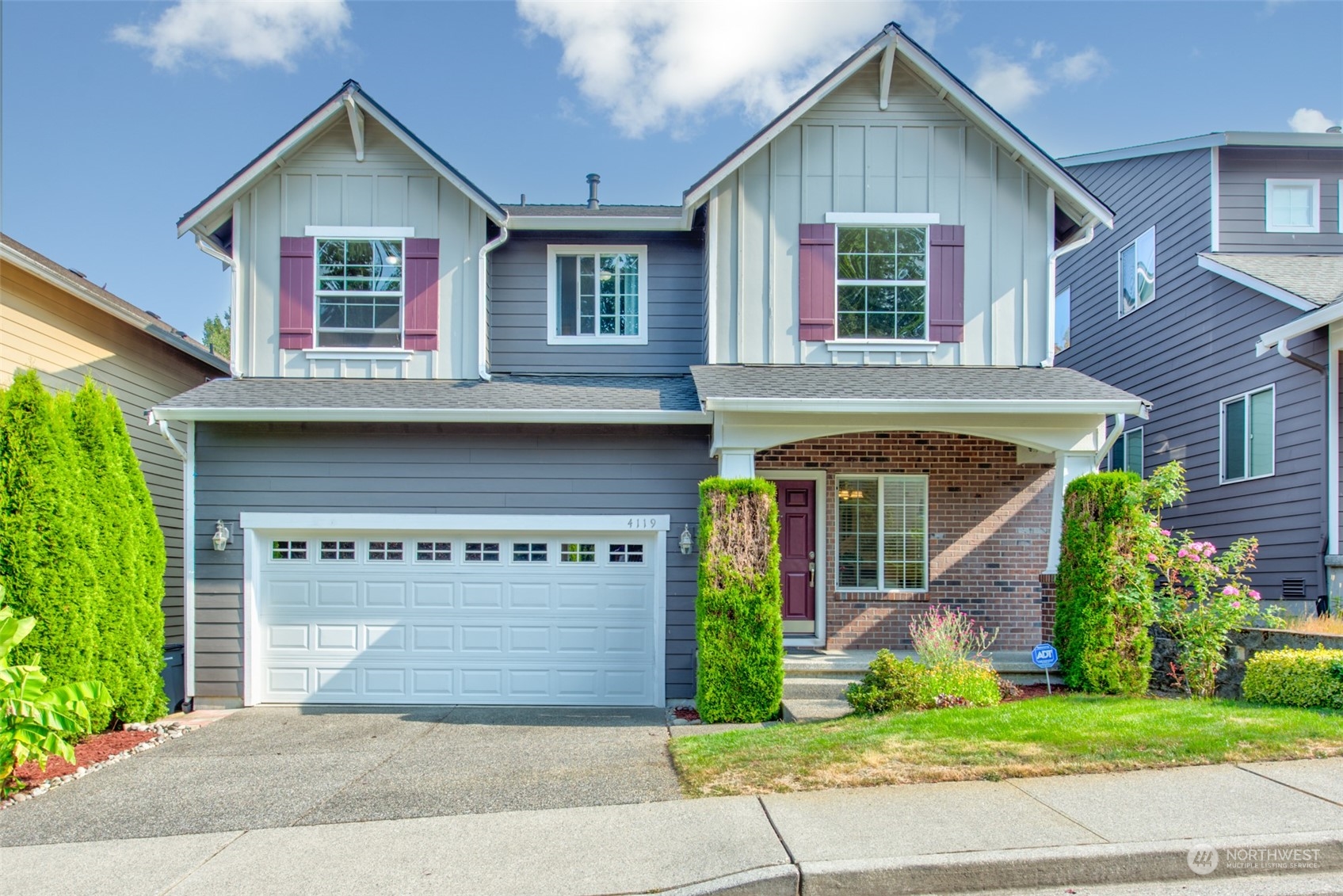 4119 240 Place Southeast Bothell, WA 98021 - Photo 1 of 32 a front view of a house with a garden and garage