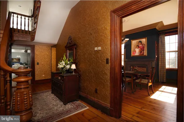 a living room with furniture and a flat screen tv with wooden floor