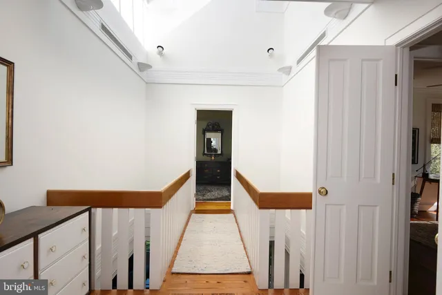 a bedroom with a bed mirror and window