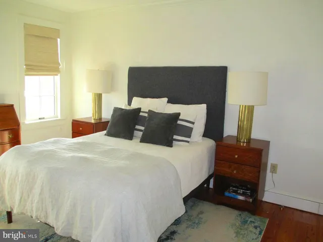 a living room with a fireplace and a rug